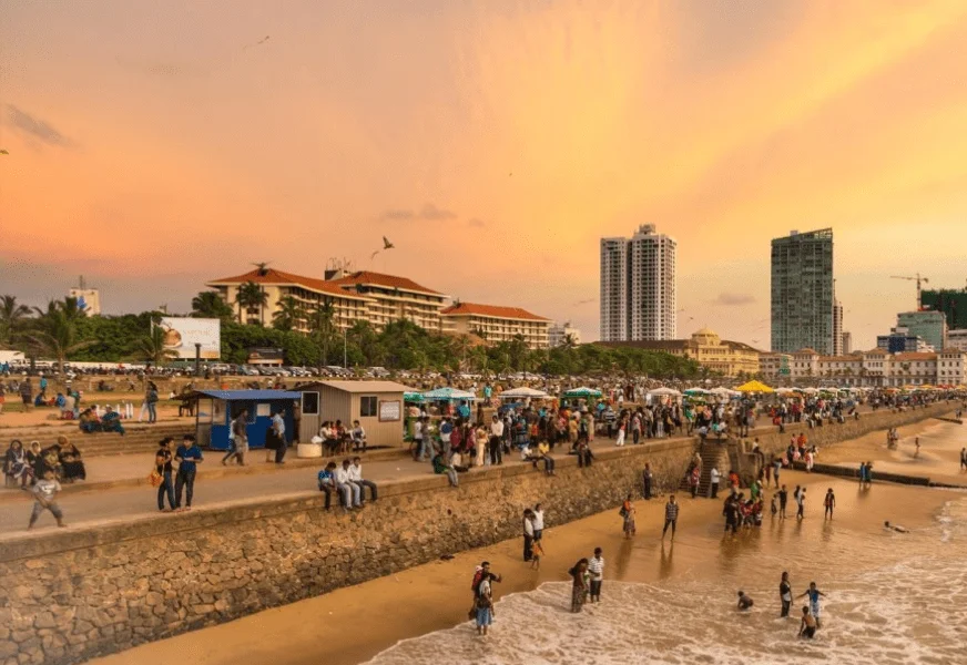 People gathering at Galle Face Green at sunset
